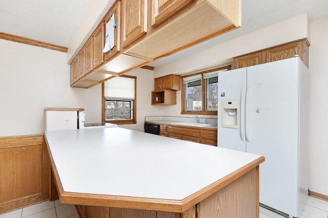 7422 Oak Brook Dr, Urbandale, IA 50322 - kitchen with a peninsula, white refrigerator with ice dispenser, light countertops, and a sink
