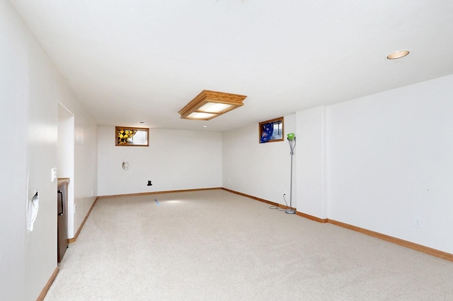 7422 Oak Brook Dr, Urbandale, IA 50322 - basement with light carpet and baseboards