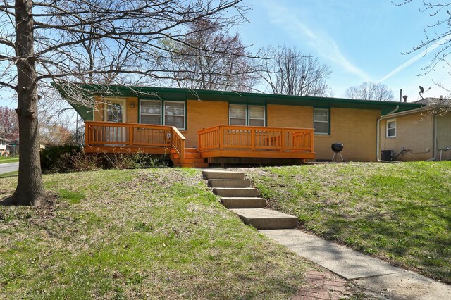 7422 Oak Brook Dr, Urbandale, IA 50322 - ranch-style house with a wooden deck, a front yard, and central AC