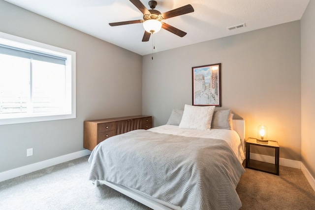 bedroom featuring carpet, visible vents, a ceiling fan, and baseboards