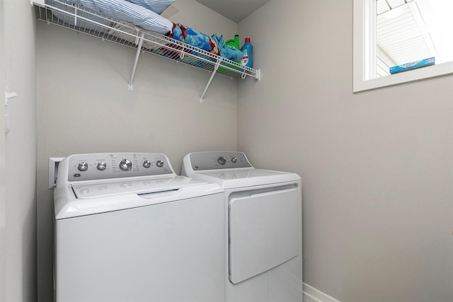 clothes washing area with washer and clothes dryer and laundry area