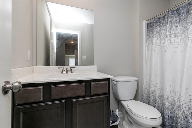 bathroom featuring toilet, a shower with curtain, and vanity