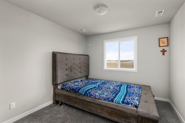 carpeted bedroom with visible vents and baseboards