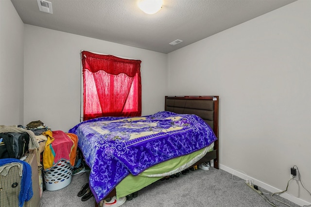 carpeted bedroom featuring baseboards and visible vents