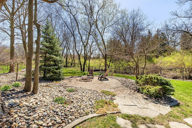 view of yard featuring fence, a patio, and an outdoor fire pit