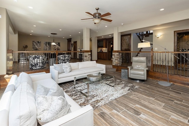 living area with ceiling fan, stairs, wood finished floors, and recessed lighting