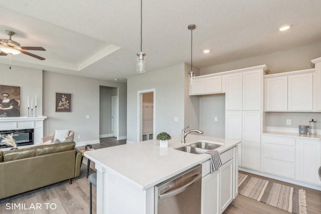 4316 NE 8th St, Ankeny, IA 50021 - kitchen with a sink, open floor plan, dishwasher, ceiling fan, and white cabinetry