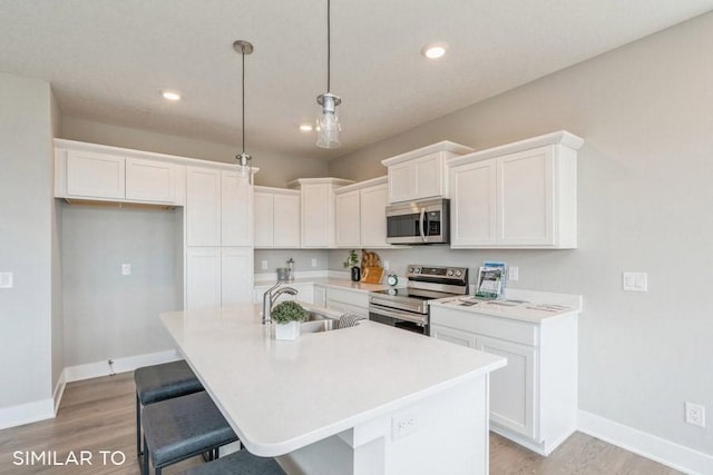 4316 NE 8th St, Ankeny, IA 50021 - kitchen with stainless steel appliances, light wood-style flooring, baseboards, and a sink