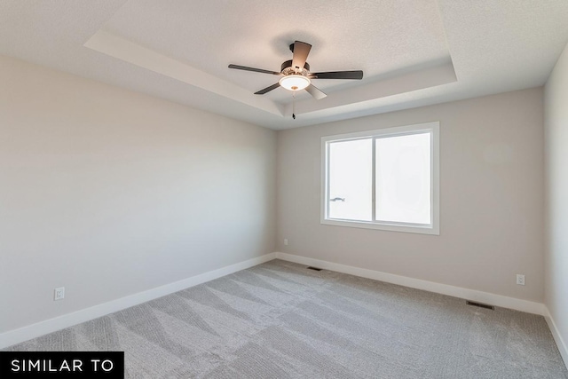 4316 NE 8th St, Ankeny, IA 50021 - spare room with a tray ceiling, visible vents, baseboards, ceiling fan, and carpet floors