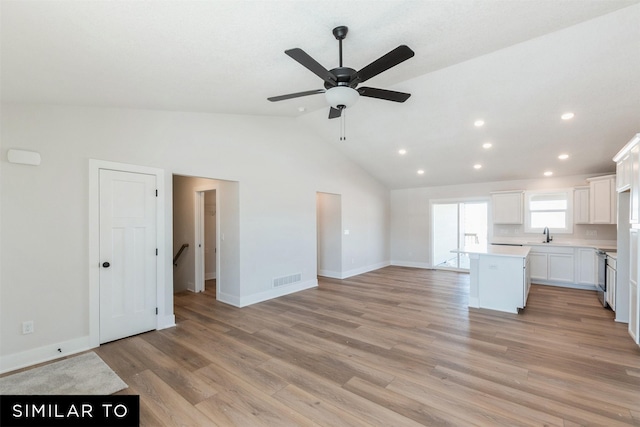 4412 NE 8th St, Ankeny, IA 50021 - unfurnished living room featuring recessed lighting, light wood finished floors, vaulted ceiling, baseboards, and ceiling fan