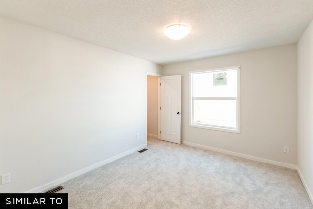 4412 NE 8th St, Ankeny, IA 50021 - spare room with a textured ceiling, baseboards, visible vents, and carpet floors