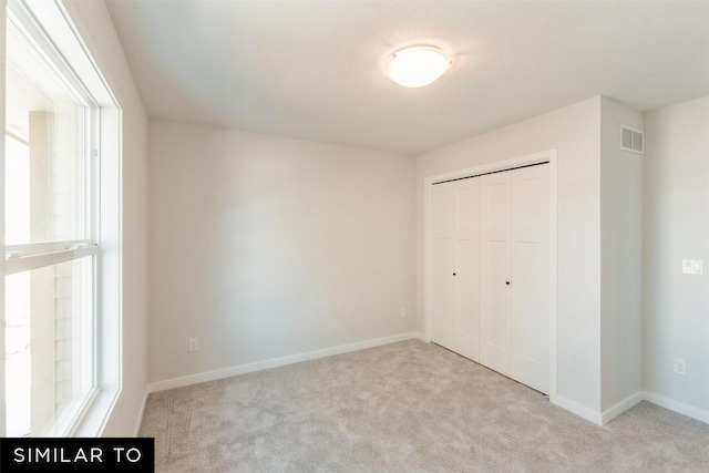 4412 NE 8th St, Ankeny, IA 50021 - unfurnished bedroom featuring a closet, carpet flooring, visible vents, and baseboards