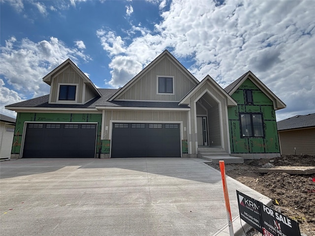 4116 NW 181st St, Clive, IA 50325 - view of front of property featuring board and batten siding, driveway, and a garage