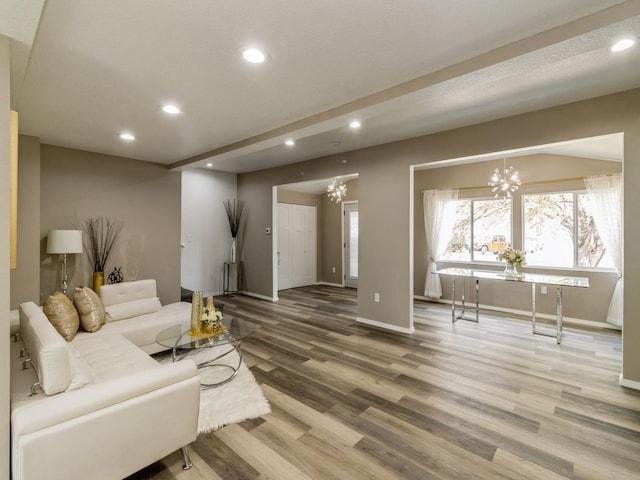 1710 Forest Ave, Des Moines, IA 50314 - living room featuring a chandelier, wood finished floors, baseboards, and recessed lighting