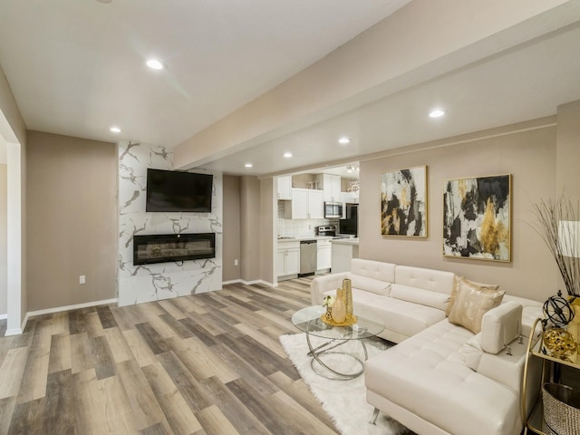 1710 Forest Ave, Des Moines, IA 50314 - living area with recessed lighting, light wood-style floors, and a premium fireplace