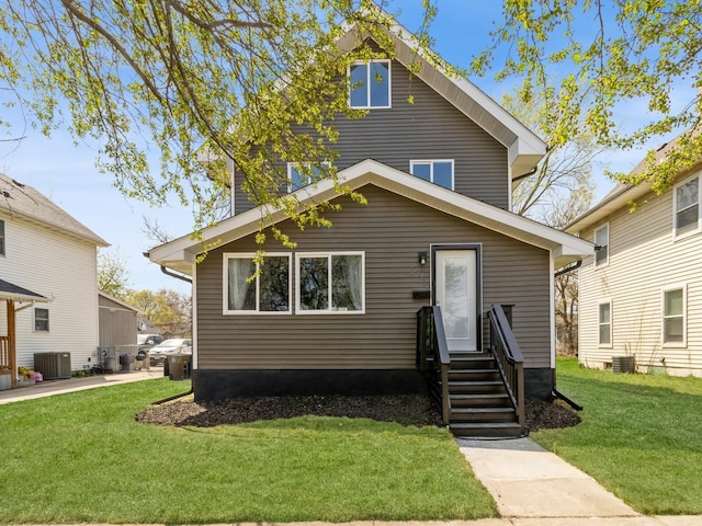 1710 Forest Ave, Des Moines, IA 50314 - american foursquare style home with entry steps, a front yard, and central air condition unit