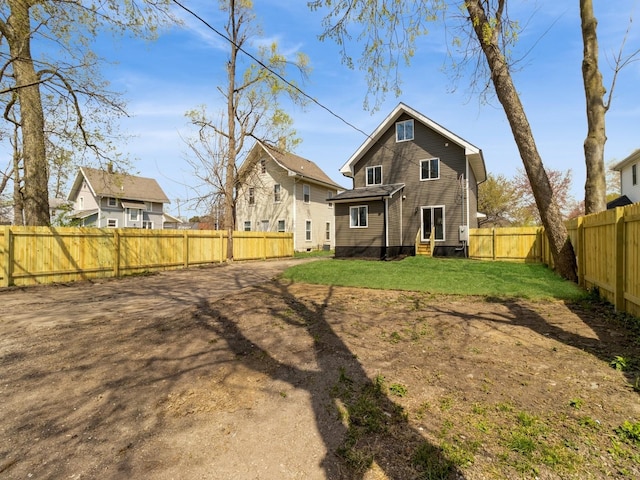 1710 Forest Ave, Des Moines, IA 50314 - rear view of property with a fenced backyard, entry steps, and a lawn