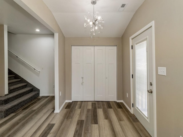 1710 Forest Ave, Des Moines, IA 50314 - foyer with stairway, plenty of natural light, wood finished floors, baseboards, and a notable chandelier