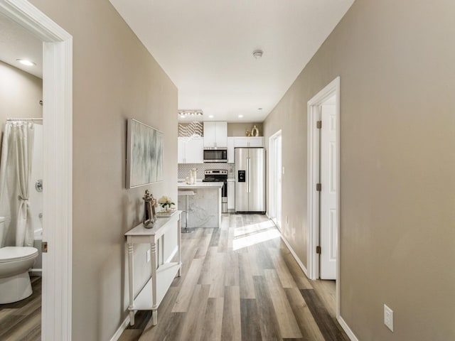 1710 Forest Ave, Des Moines, IA 50314 - hall with light wood-style flooring, baseboards, and recessed lighting