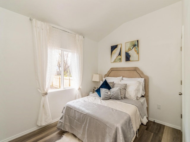 1710 Forest Ave, Des Moines, IA 50314 - bedroom with lofted ceiling, baseboards, and wood finished floors