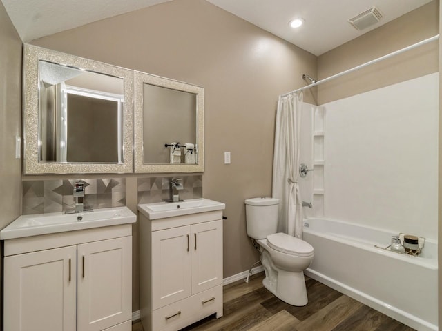 1710 Forest Ave, Des Moines, IA 50314 - bathroom featuring wood finished floors, visible vents, a sink, and toilet