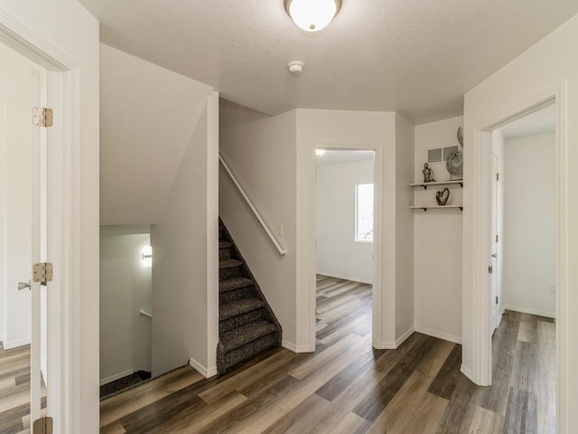 1710 Forest Ave, Des Moines, IA 50314 - entryway with baseboards, wood finished floors, a textured ceiling, and stairs