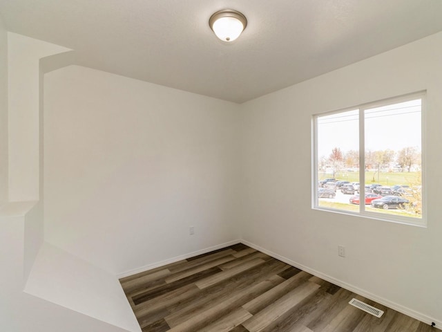 1710 Forest Ave, Des Moines, IA 50314 - unfurnished room with visible vents, baseboards, and wood finished floors
