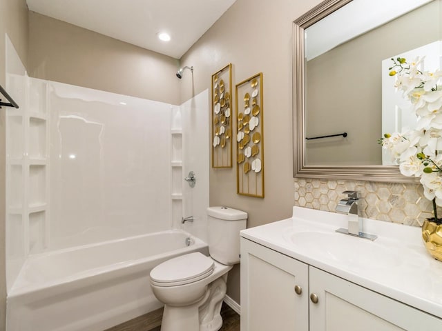 1710 Forest Ave, Des Moines, IA 50314 - bathroom with toilet, backsplash, wood finished floors, shower / bath combination, and vanity