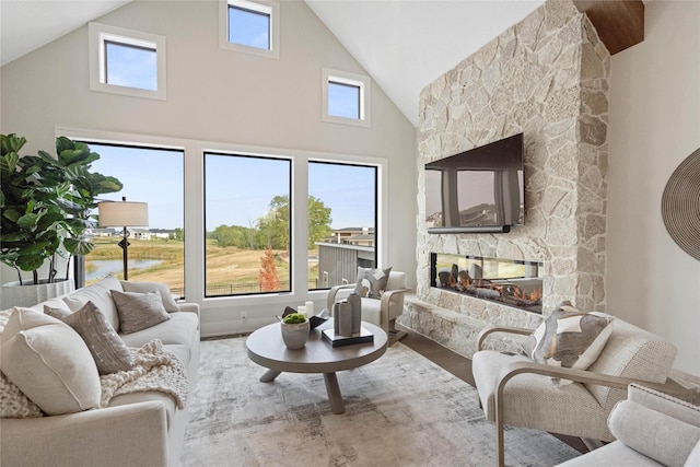 3815 NW 183rd St, Clive, IA 50325 - living area featuring a stone fireplace, high vaulted ceiling, and wood finished floors