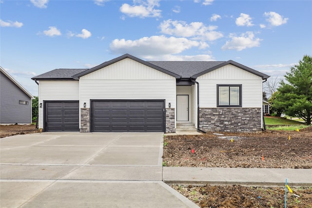 2311 N 8th Ave E, Newton, IA 50208 - modern inspired farmhouse featuring stone siding, a garage, concrete driveway, and a shingled roof