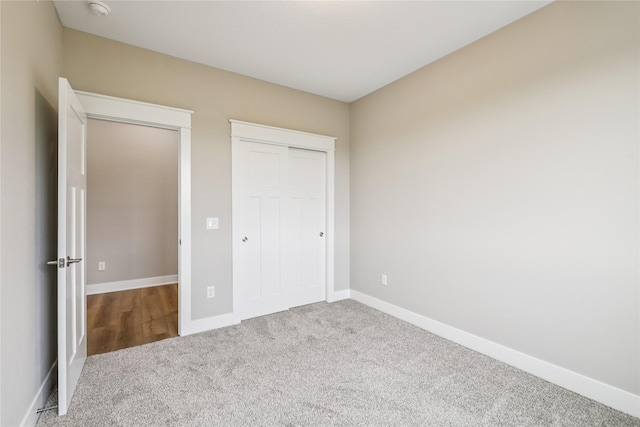 2311 N 8th Ave E, Newton, IA 50208 - unfurnished bedroom featuring carpet and a closet