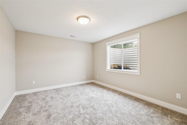 2311 N 8th Ave E, Newton, IA 50208 - carpeted spare room featuring baseboards