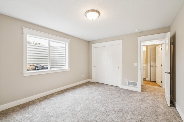 2311 N 8th Ave E, Newton, IA 50208 - unfurnished bedroom with carpet flooring and a closet