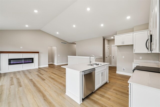2311 N 8th Ave E, Newton, IA 50208 - kitchen featuring stainless steel appliances, white cabinets, open floor plan, light countertops, and light wood finished floors