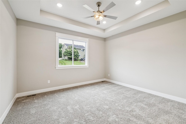 2311 N 8th Ave E, Newton, IA 50208 - spare room with carpet, a tray ceiling, ceiling fan, and recessed lighting