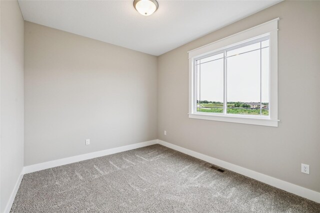 2311 N 8th Ave E, Newton, IA 50208 - spare room with carpet floors and baseboards
