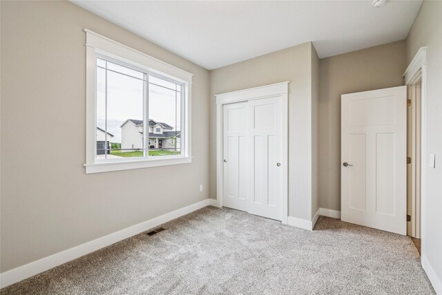 2311 N 8th Ave E, Newton, IA 50208 - unfurnished bedroom with carpet and a closet