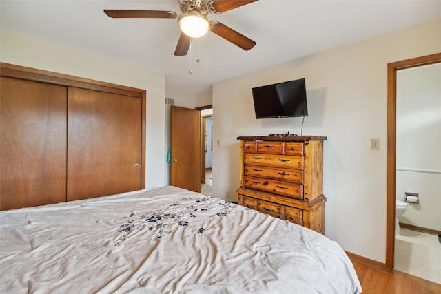 bedroom with light wood finished floors, a ceiling fan, ensuite bath, a closet, and baseboards