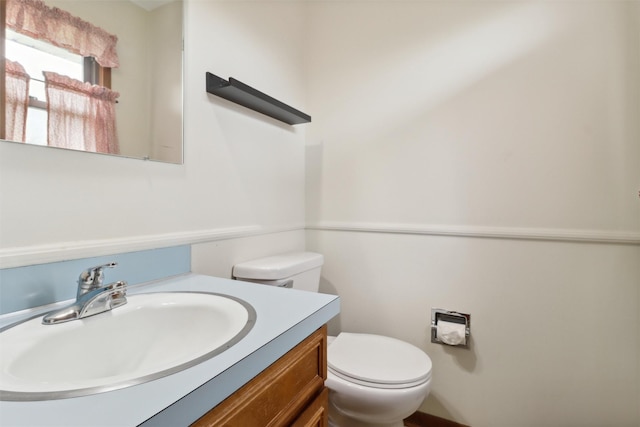 half bathroom with toilet and vanity