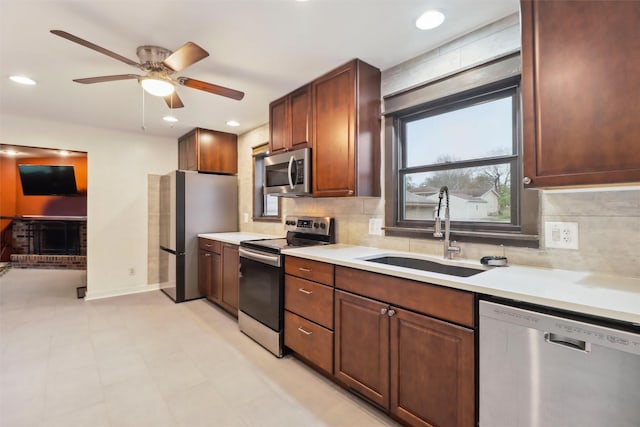7300 Prairie Ave, Urbandale, IA 50322 - kitchen with appliances with stainless steel finishes, light countertops, decorative backsplash, a ceiling fan, and recessed lighting
