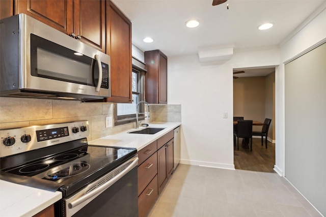 7300 Prairie Ave, Urbandale, IA 50322 - kitchen featuring stainless steel appliances, tasteful backsplash, and recessed lighting