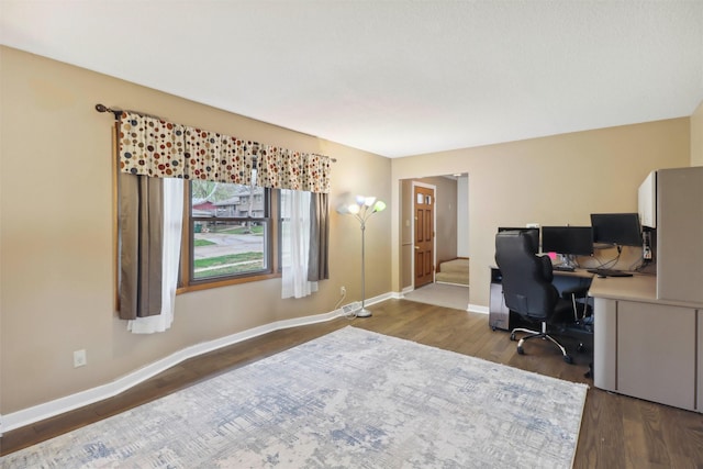 office with baseboards and dark wood-style flooring