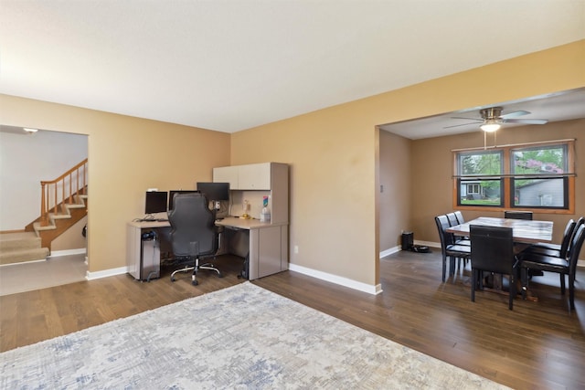 office area featuring dark wood finished floors, baseboards, and ceiling fan