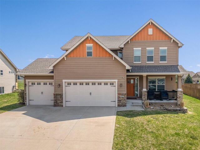 2307 SE 17th St, Ankeny, IA 50021 - craftsman-style home with a porch, stone siding, board and batten siding, and a garage