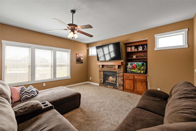 2307 SE 17th St, Ankeny, IA 50021 - carpeted living room featuring baseboards, a ceiling fan, a textured ceiling, and a fireplace