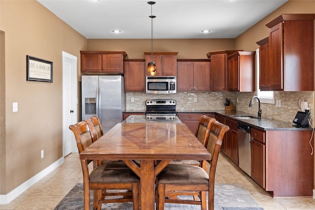 2307 SE 17th St, Ankeny, IA 50021 - kitchen with a sink, baseboards, dark stone counters, decorative backsplash, and appliances with stainless steel finishes