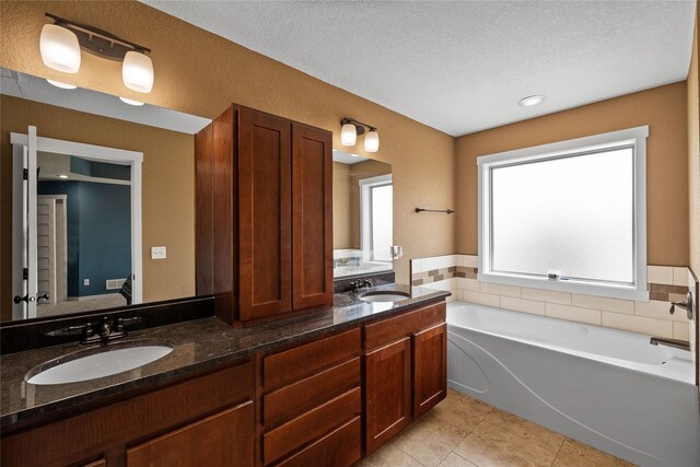 2307 SE 17th St, Ankeny, IA 50021 - bathroom with a bath, a sink, tile patterned flooring, and double vanity