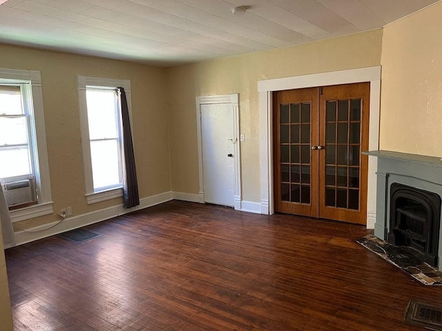 842 16th St Unit 4, Des Moines, IA 50314 - unfurnished living room with a fireplace with flush hearth, dark wood finished floors, baseboards, and french doors