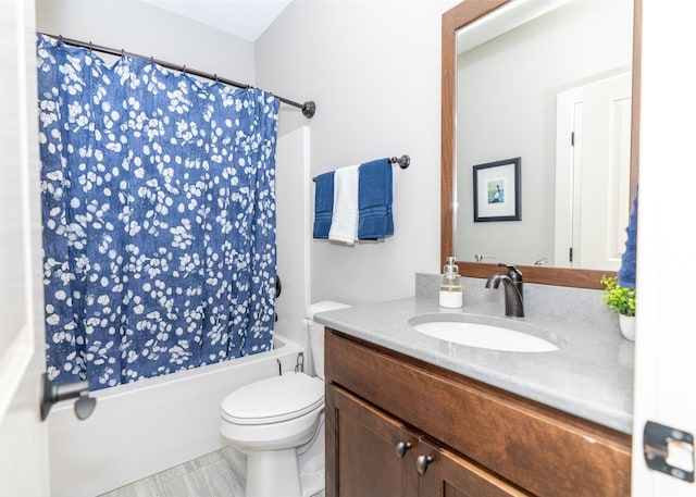 full bathroom with shower / bath combo with shower curtain, toilet, and vanity