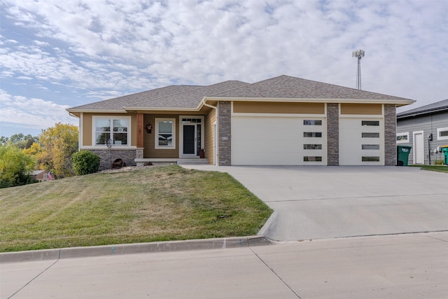 view of front of house with a garage, a front yard, stone siding, a shingled roof, and concrete driveway